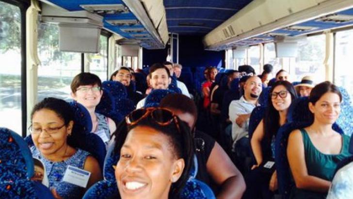 hoto of conference attendees on a bus tour of New Orleans' post-Katrina schools landscape.